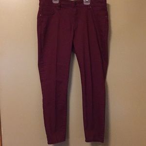 Burgundy stretch jeans.